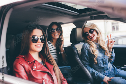 Three beautiful young women friends have fun in the o car as they go on a road trip © F8  \ Suport Ukraine