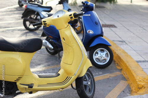 Yellow and blue scooters in the parking lot