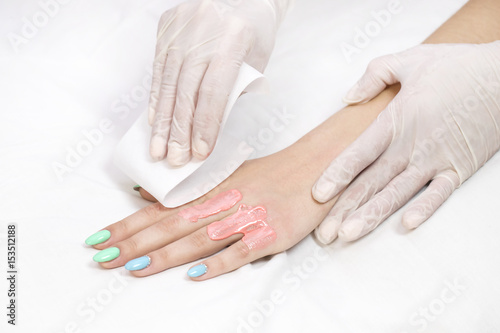 Process depilation female legs and hands in a beauty salon 