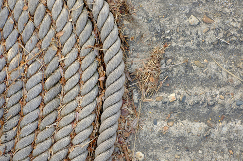 Old rope on a concrete ground © Maxim
