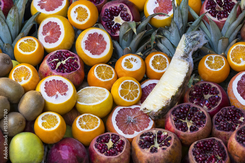 Fototapeta Naklejka Na Ścianę i Meble -  Background of fresh fruits of pomegranate oranges kiwi, pineapple 
