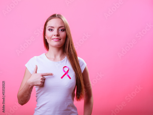 Woman wih pink cancer ribbon on chest