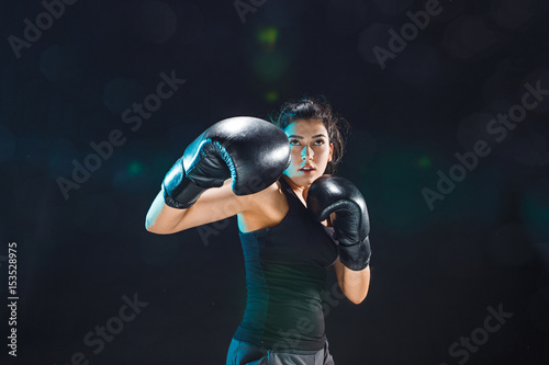 The female boxer training at sport club © master1305