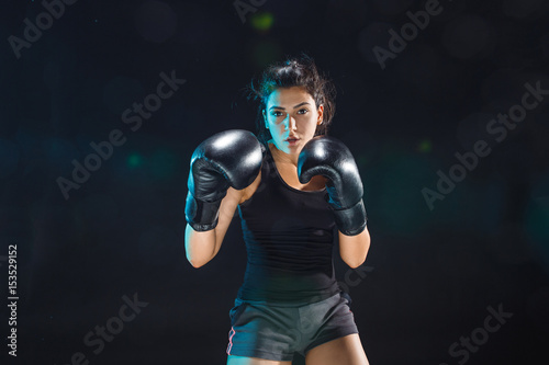 The female boxer training at sport club