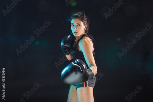 The female boxer training at sport club