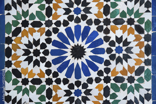 Complex, beautiful Moroccan mosaic, in a traditional Moorish, Islamic design covering walls, floors and fountains, in Marrakesh, Morocco photo