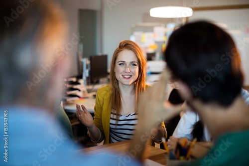 Smiling woman talking to her team