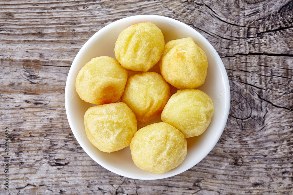Bowl of potato balls on wood, from above Bowl of potato balls on wood, from above