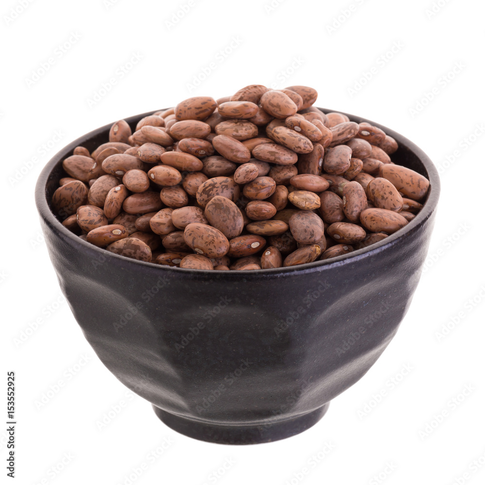 pinto beans in a ceramic bowl isolated on a white background. pinto beans in a ceramic bowl isolated on a white background.