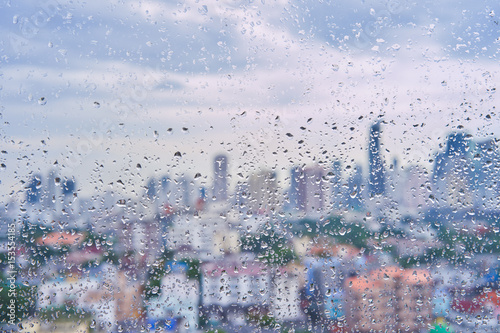 Photography Rain drops on window with blur city view