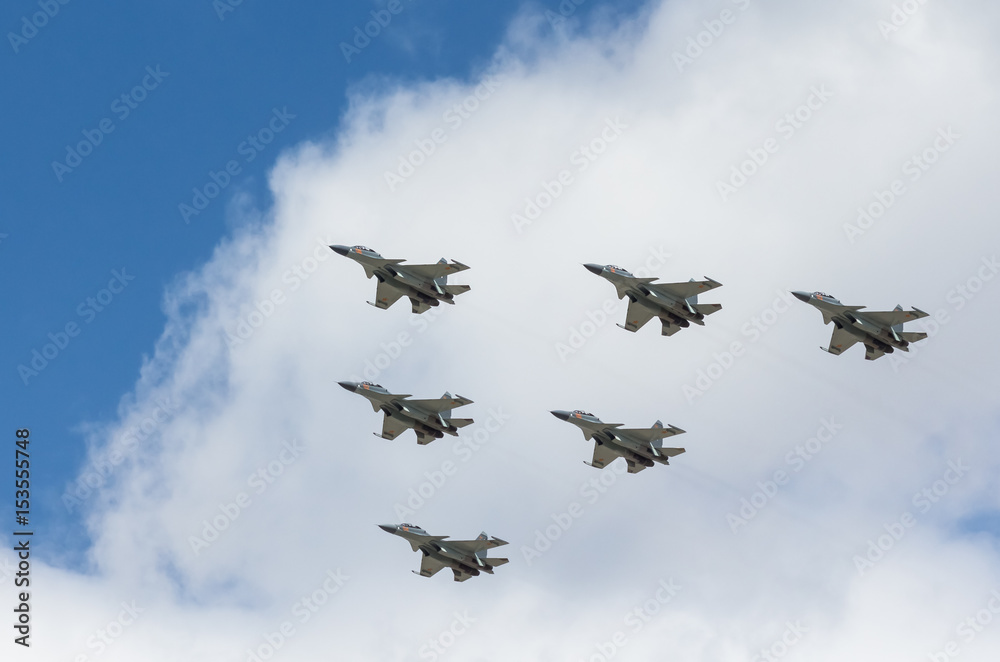 War planes in blue sky with clouds at the victory parade in the capital of Kazakhstan Astana in 2017 War planes in blue sky with clouds at the victory parade in the capital of Kazakhstan Astana in 2017