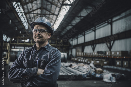 Portrait of male worker standing in metal industry photo