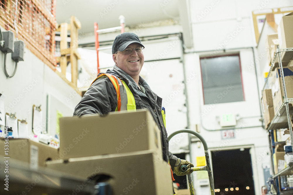 Portrait of smiling worker in warehouse Portrait of smiling worker in warehouse