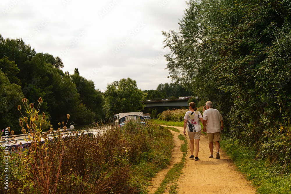 Countryside landscape and a couple walking along the river Countryside landscape and a couple walking along the river