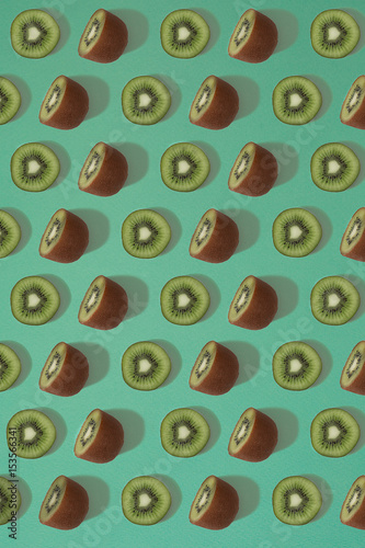 Pattern of kiwi. Top view of the sliced kiwi on blue background. Minimal flat lay concept.