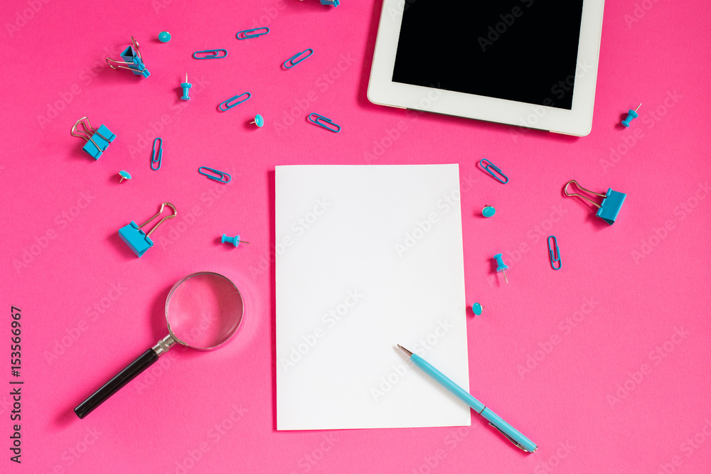 Stationery on a pink background. Paper clips and binders Stationery on a pink background. Paper clips and binders