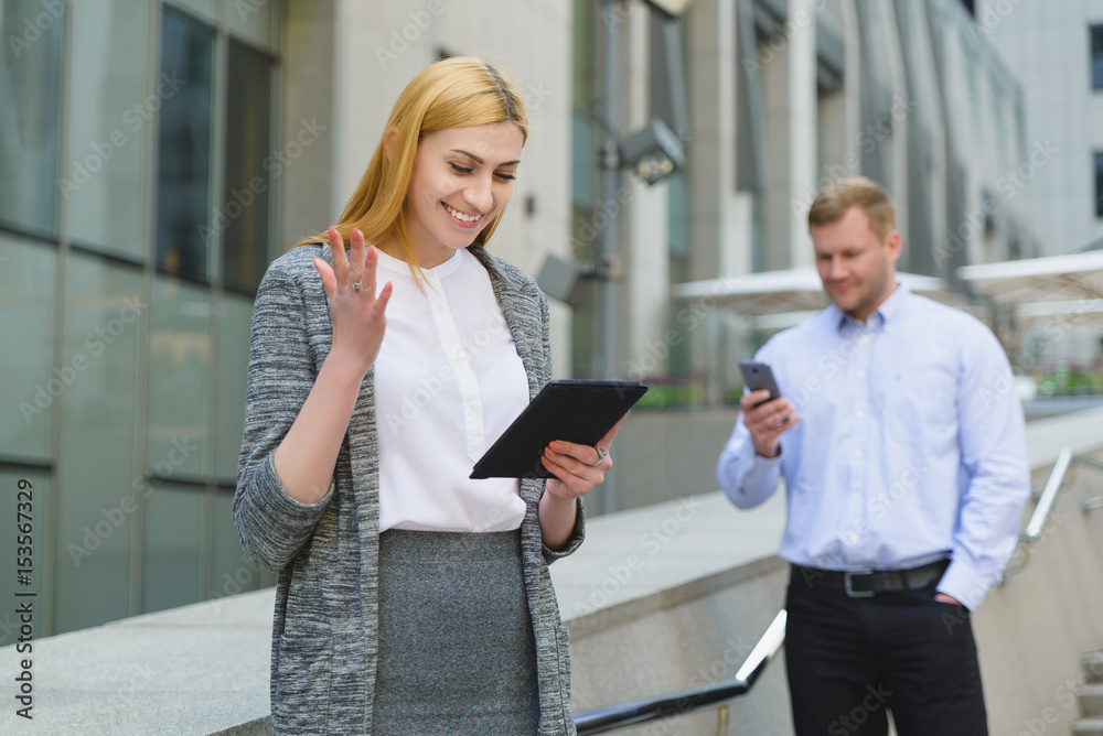 Two cheerful happy young business people taking online meeting outdoor Two cheerful happy young business people taking online meeting outdoor