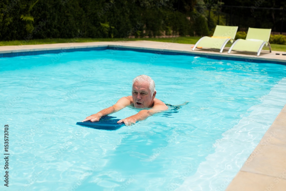 Senior man swimming in the pool