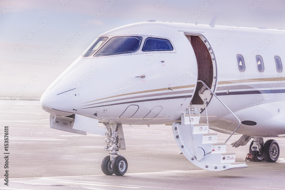 Private jet plane parking at the airport. Private airplane at sunset, Private jet plane parking at the airport. Private airplane at sunset,