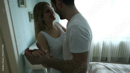 Couple in love dancing in room and ending foreplay on bed photo