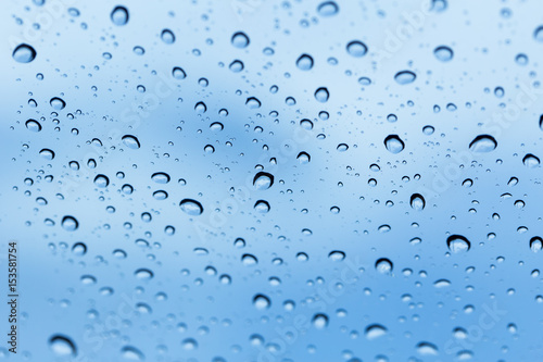 rain water drops with blur blue sky background.