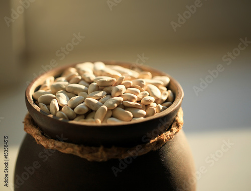 White beans in a ceramic cup. photo