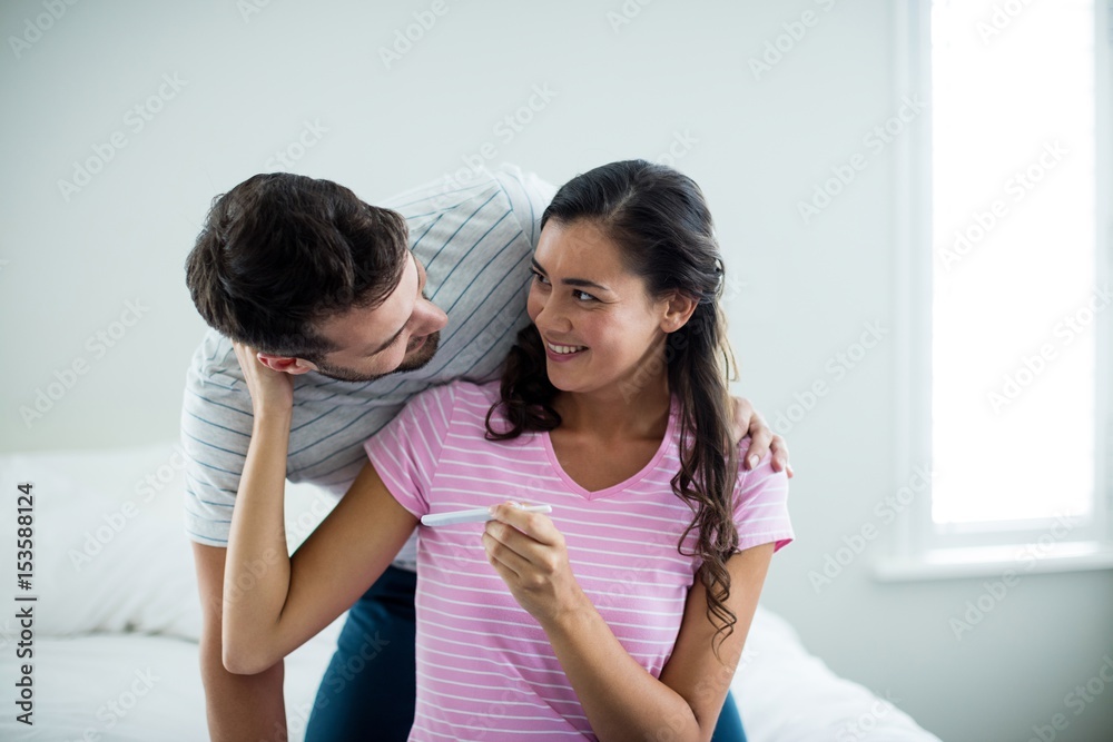 Joyful couple finding results of a pregnancy test Joyful couple finding results of a pregnancy test