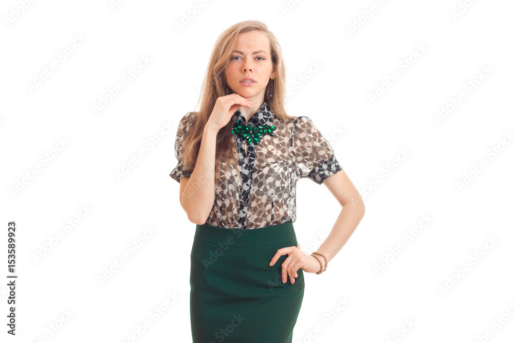 beautiful young girl with blond hair and attire keeps one hand near the face and the other on the side and looks straight beautiful young girl with blond hair and attire keeps one hand near the face and the other on the side and looks straight