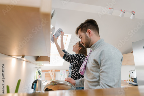 Beautiful young couple cooking spaghetti in the kitchen photo