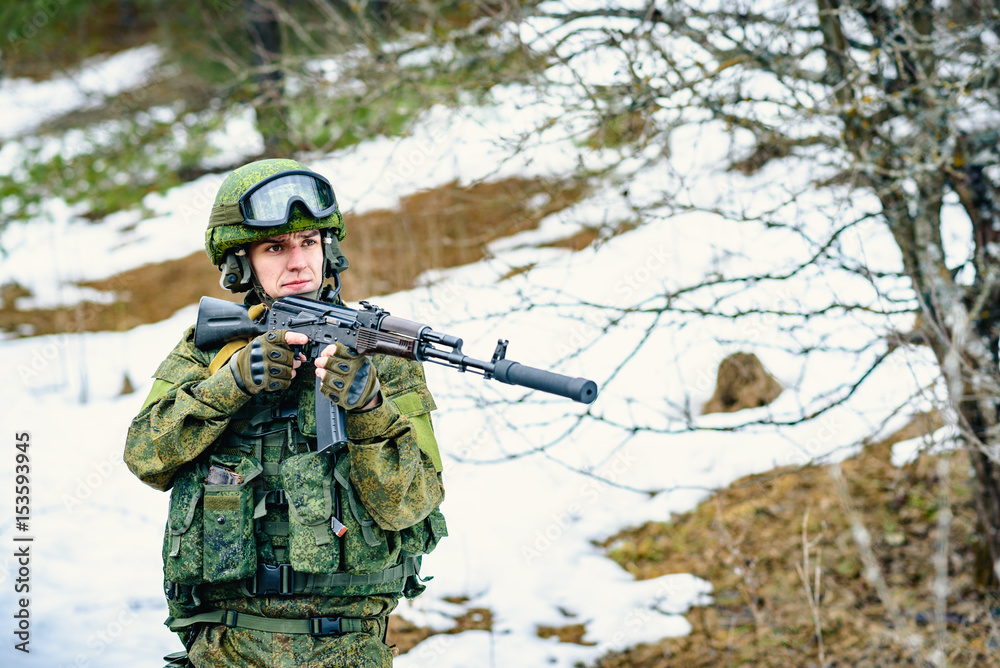 The soldier of the Russian army with a submachine gun keeps on sight, the area under protection The soldier of the Russian army with a submachine gun keeps on sight, the area under protection