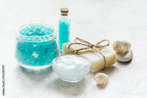 blue sea salt, soap and body cream on stone desk background
