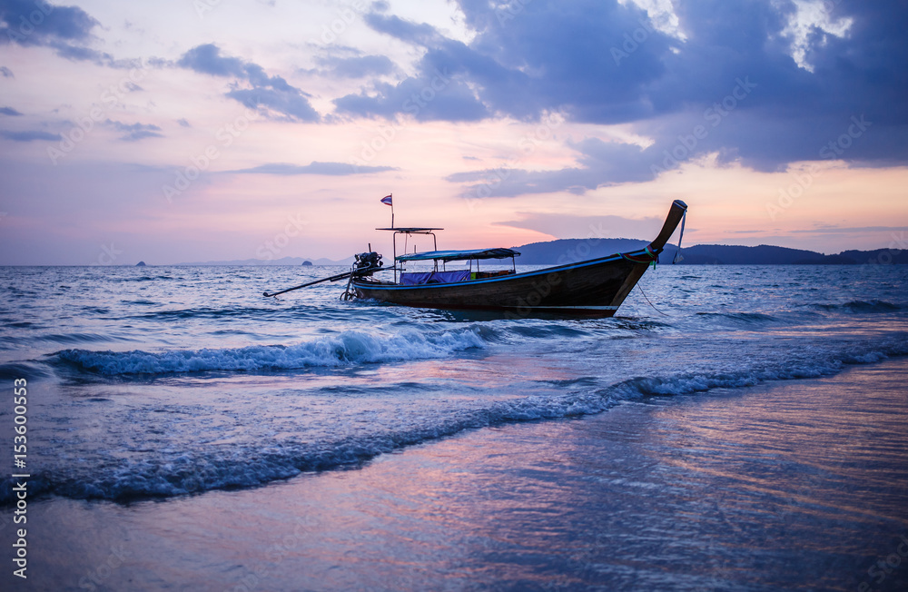 Longtail boat on sunrise.