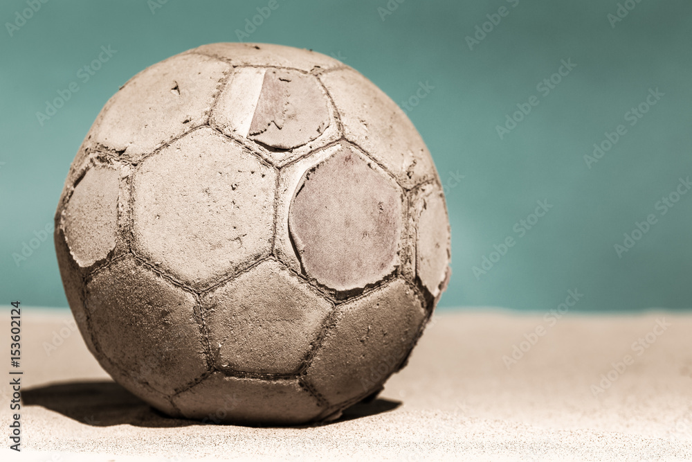 un vieux ballon de foot usé sur du sable avec un arrière plan vintage  Photos | Adobe Stock