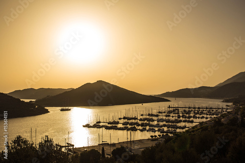 Sunset over the sea and mountains. Port with yachts. Turkey  Oludeniz.