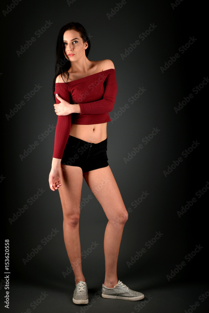 Beautiful woman posing in studio on dark background Beautiful woman posing in studio on dark background