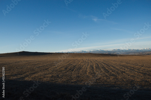 field at dawn, the Caucasus , sky blue.