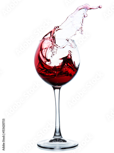 Red wine splashing in a glass