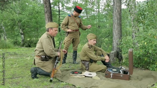The army of the USSR. Soviet army soldiers are resting. Soldiers listen to a gramophone. Soviet Union soldiers in camp. Reconstruction of the Soviet army.