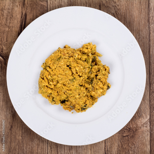 Vegetarian food on a plate with wooden background