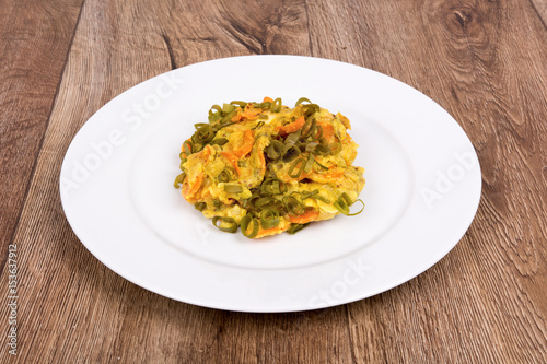 Vegetarian food on a plate with wooden background