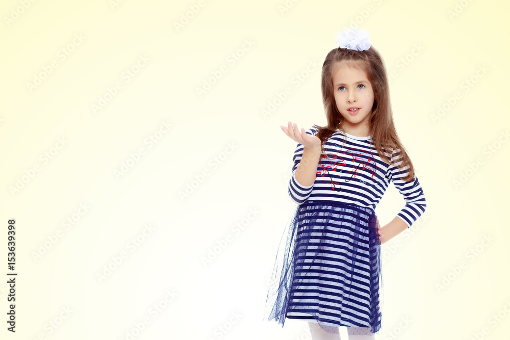 Cute little girl posing in front of the camera. Cute little girl posing in front of the camera.