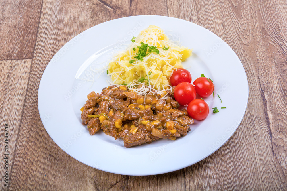 Vegetarian food on a plate with wooden background Vegetarian food on a plate with wooden background