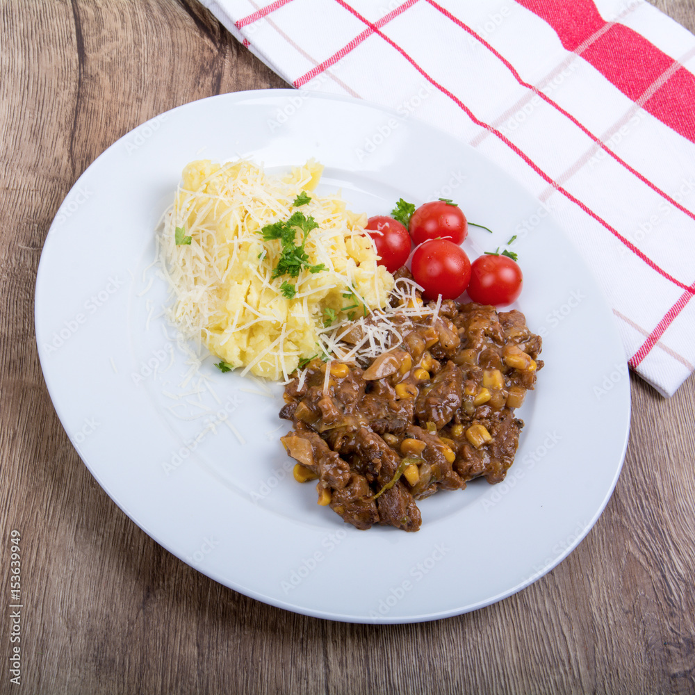 Vegetarian food on a plate with wooden background Vegetarian food on a plate with wooden background