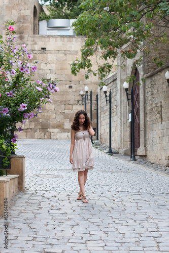 Young girl near old wall © Saida