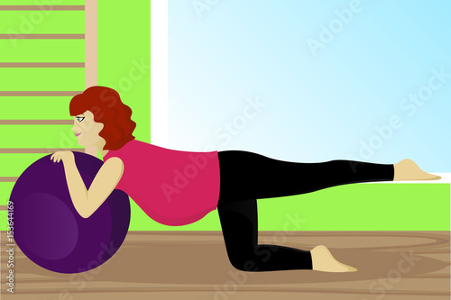 Pregnant woman on fitness ball in gym