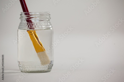 Paint brush in a jar filled with water
