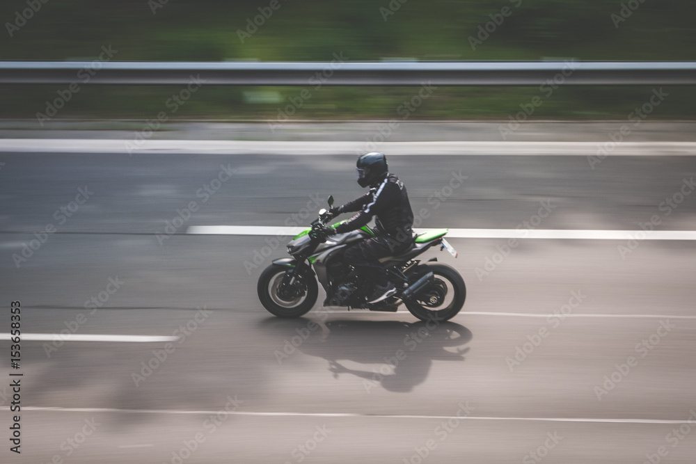 motorbike driving   on highway , motion blur