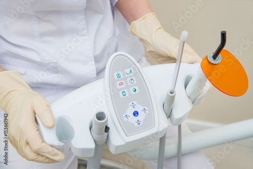 Nurse holding Dental UV curing light lamp . Ultraviolet polymerization lamp with Orange blocking glass. photo