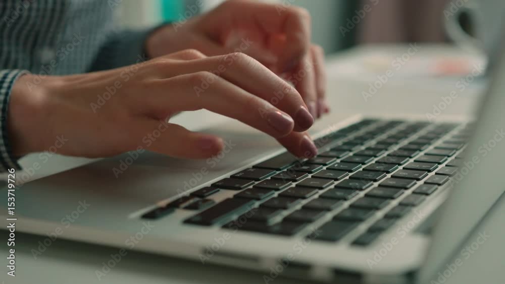 Close up woman typing on the laptop keyboard. Female hands typing on the keyboard. Dolly shot Close up woman typing on the laptop keyboard. Female hands typing on the keyboard. Dolly shot