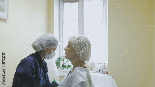 A female employee of a cosmetology clinic makes markup before the microblasting procedure photo